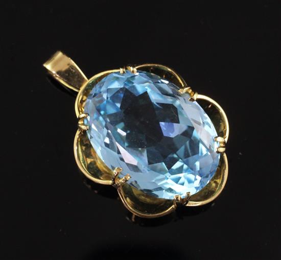 An 18ct gold and solitaire blue topaz pendant, overall 1.5in.